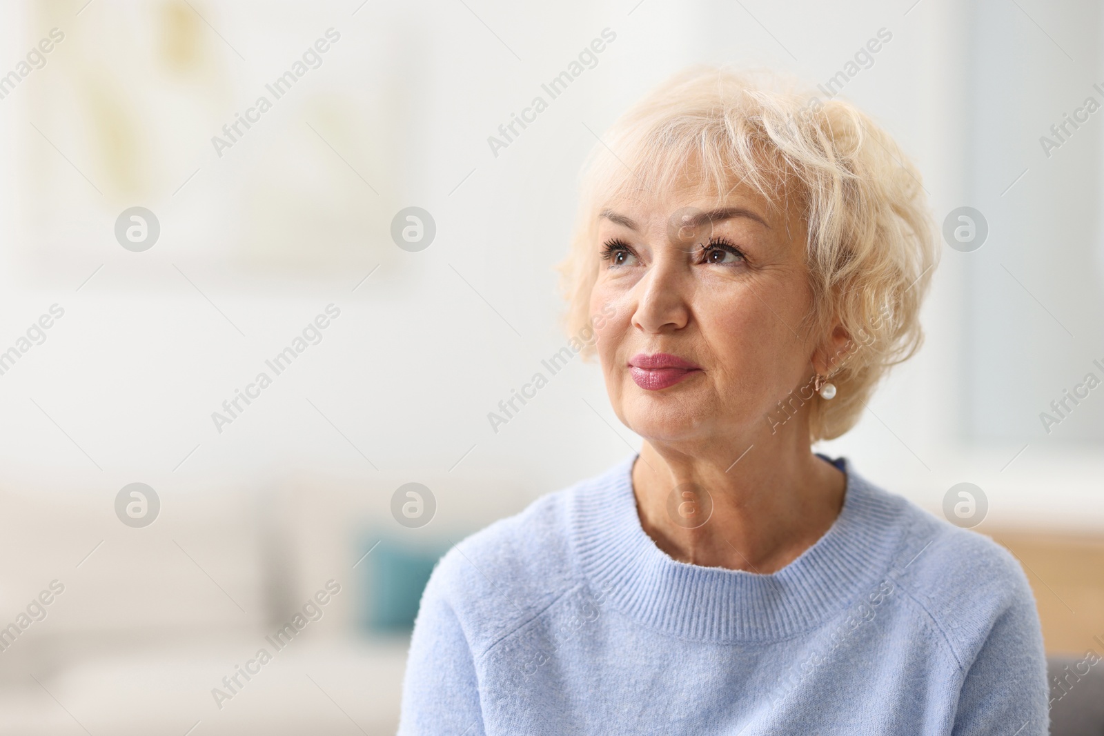 Photo of Portrait of grandmother at home. Space for text