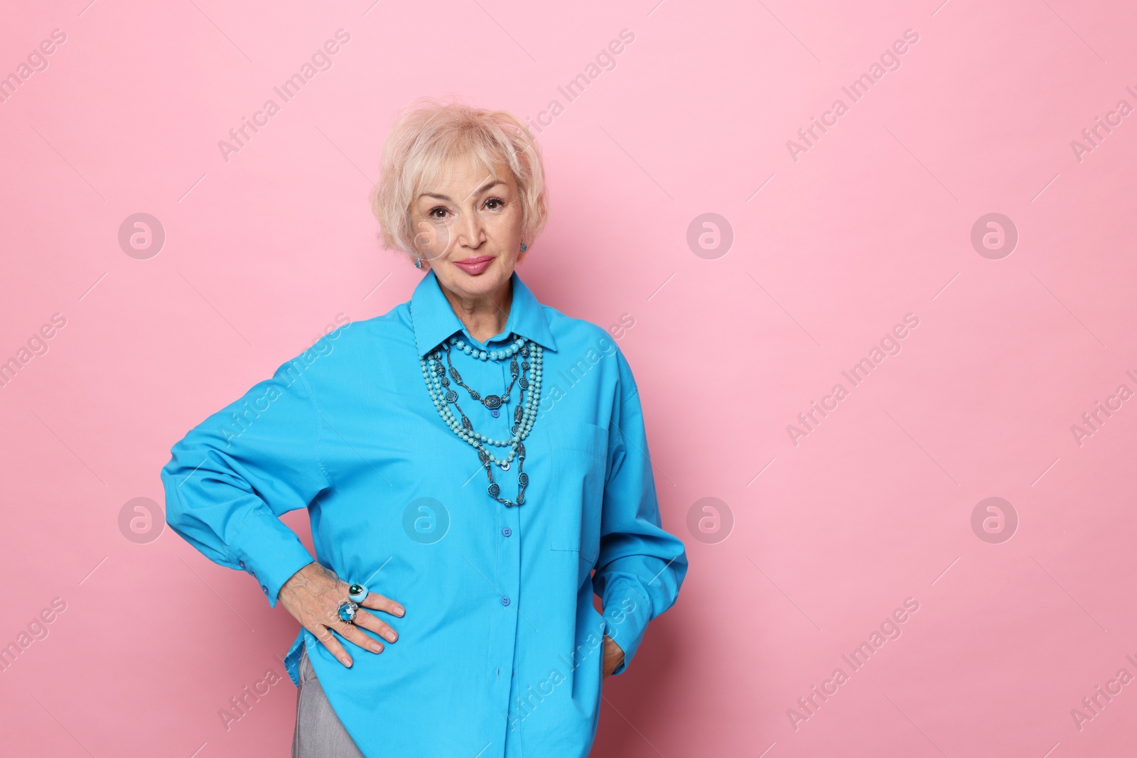 Photo of Portrait of elegant grandmother on pink background. Space for text