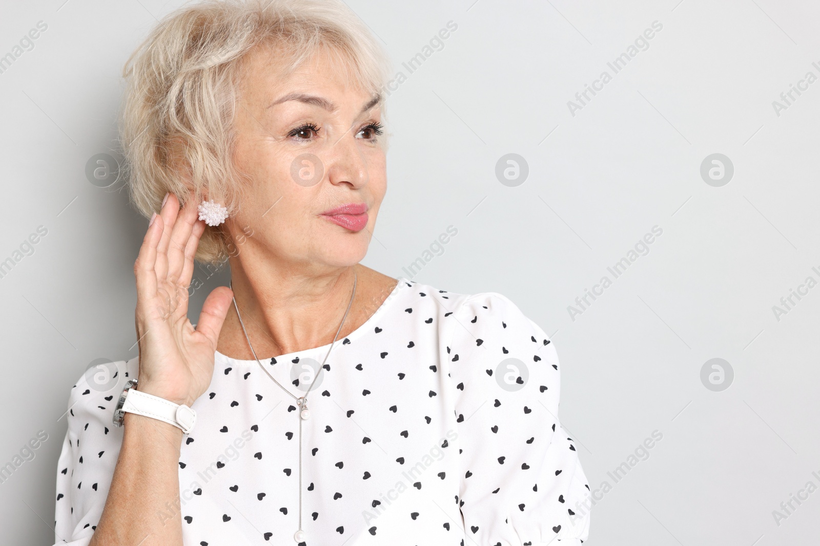 Photo of Portrait of grandmother on light grey background. Space for text