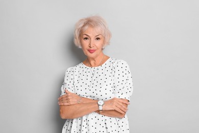 Photo of Portrait of elegant grandmother on light grey background