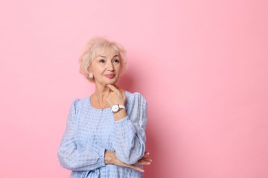 Photo of Portrait of elegant grandmother on pink background. Space for text