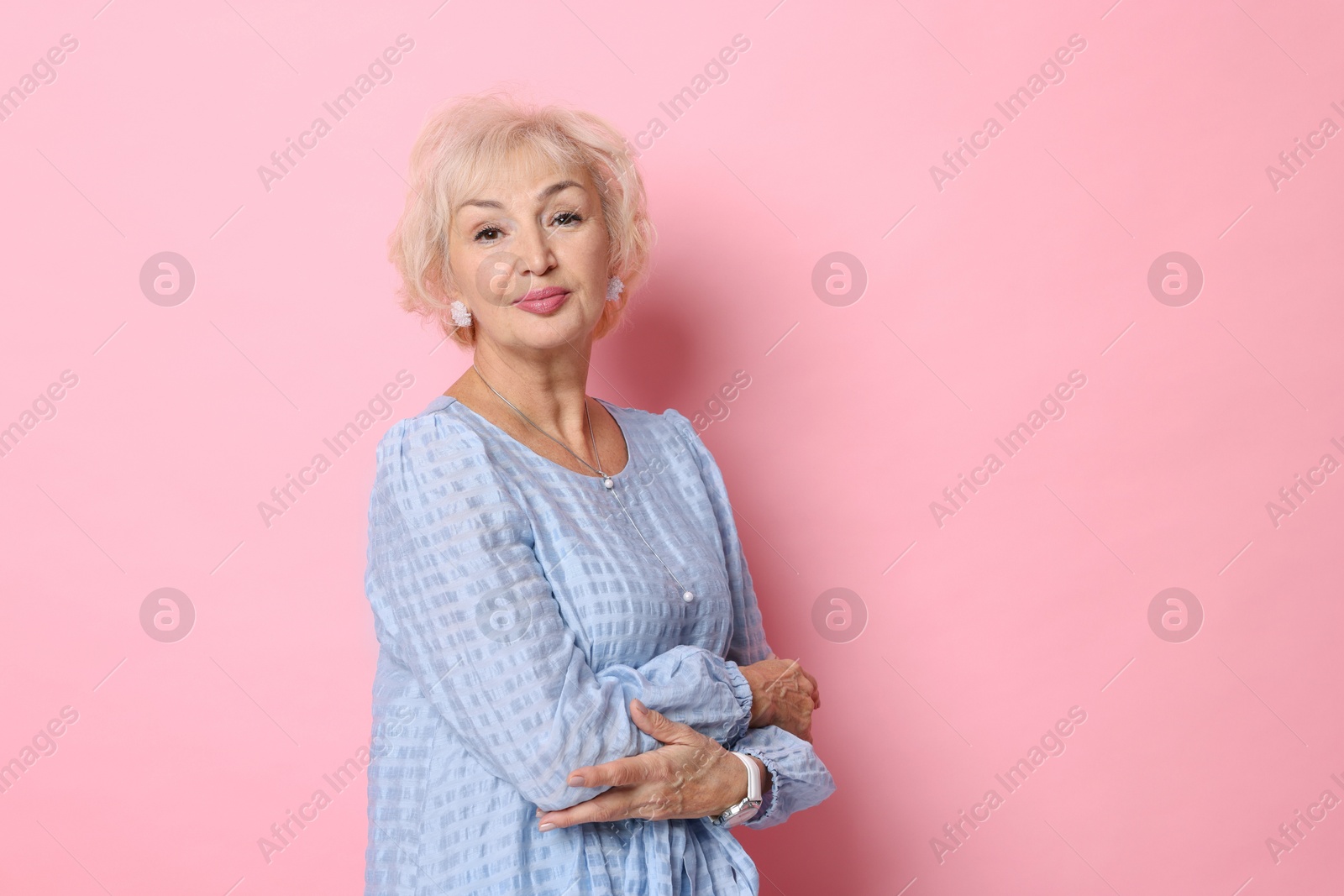 Photo of Portrait of elegant grandmother on pink background. Space for text