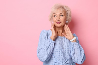 Photo of Portrait of elegant grandmother on pink background. Space for text