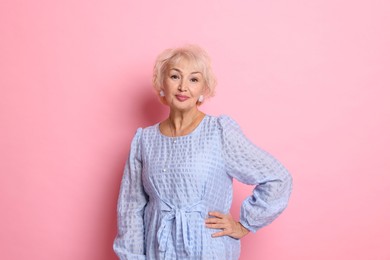 Photo of Portrait of elegant grandmother on pink background