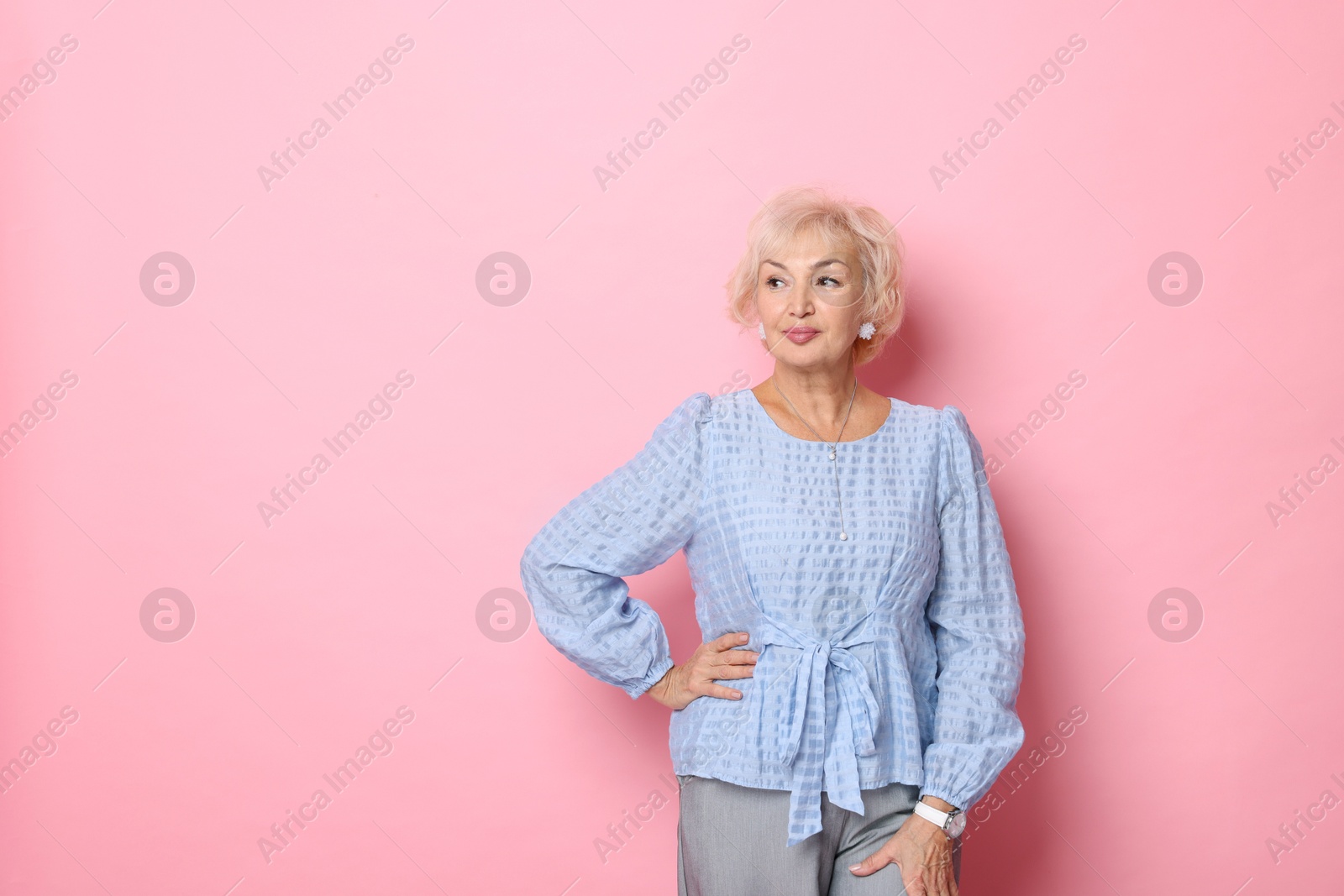 Photo of Portrait of elegant grandmother on pink background. Space for text