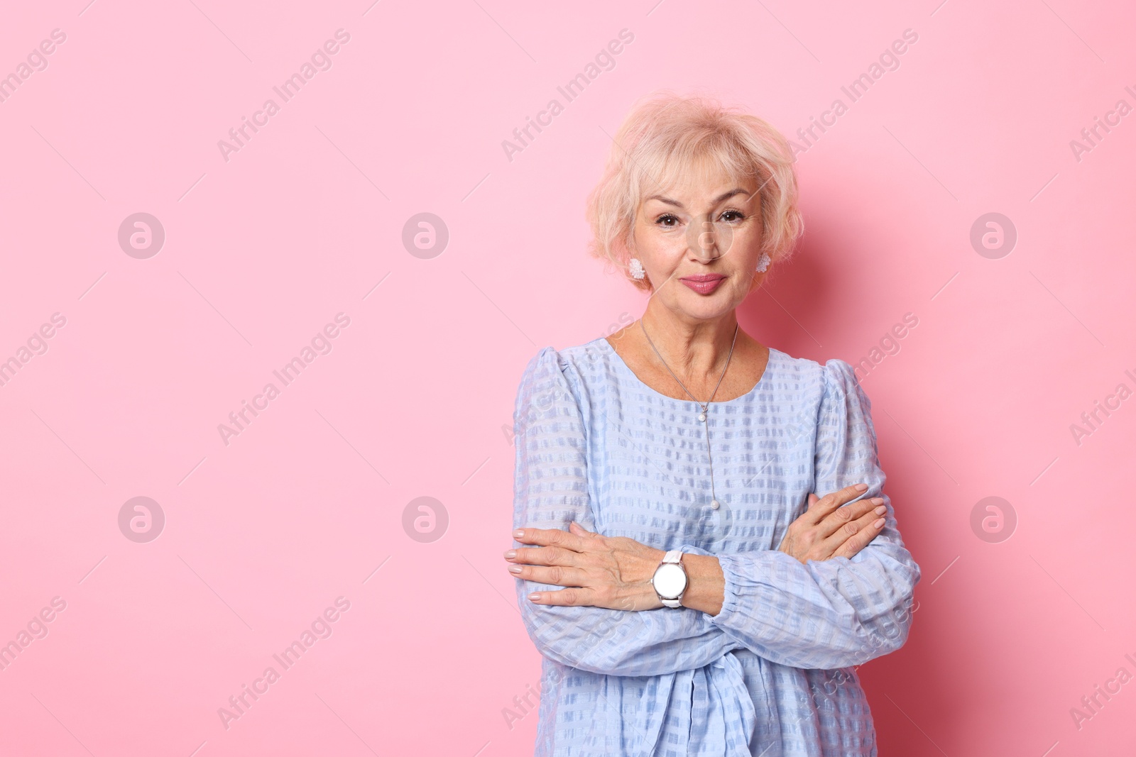 Photo of Portrait of elegant grandmother on pink background. Space for text