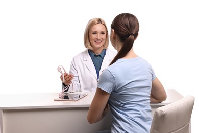 Photo of Weight loss. Smiling nutritionist consulting patient at table against white background