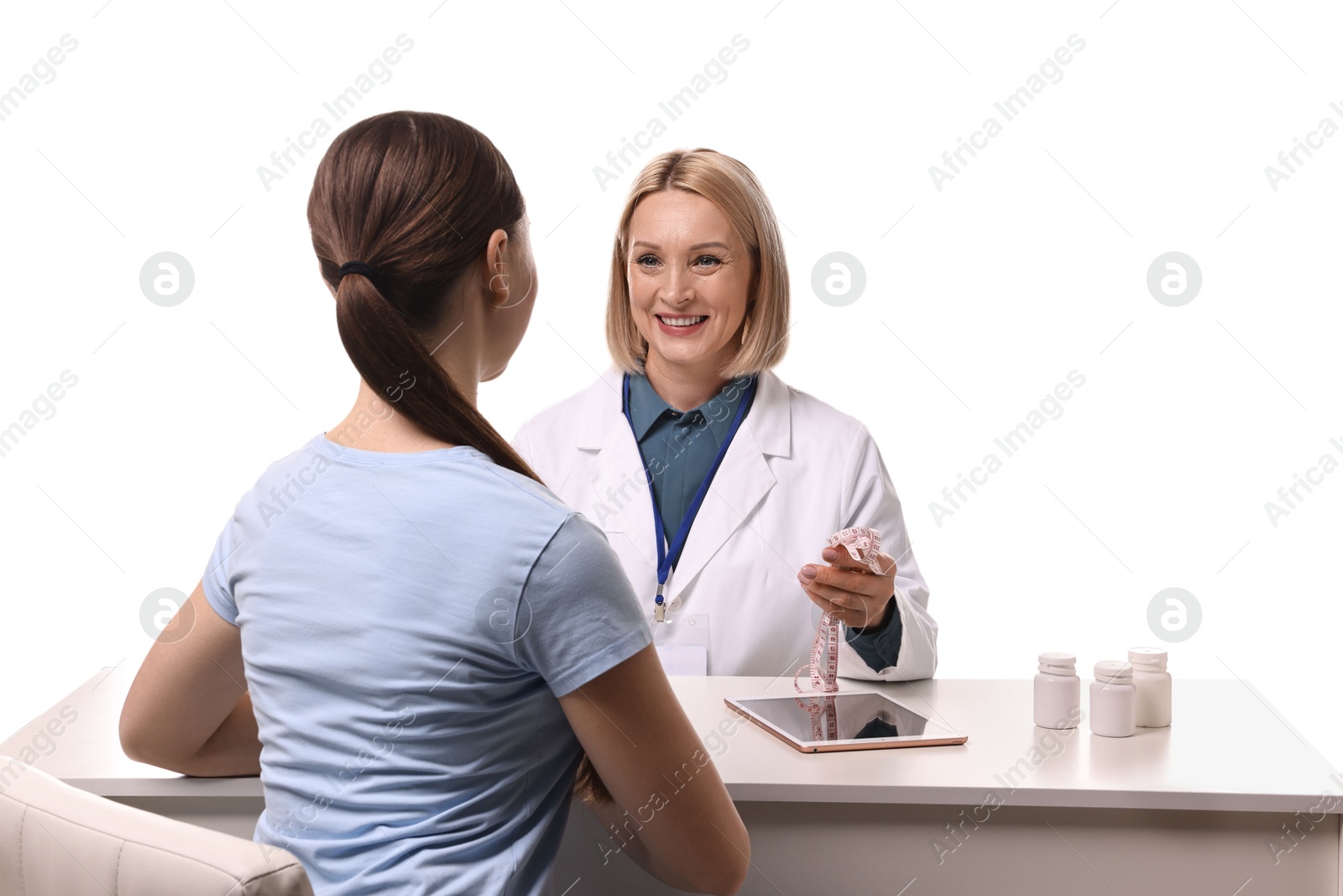 Photo of Weight loss. Smiling nutritionist consulting patient at table against white background