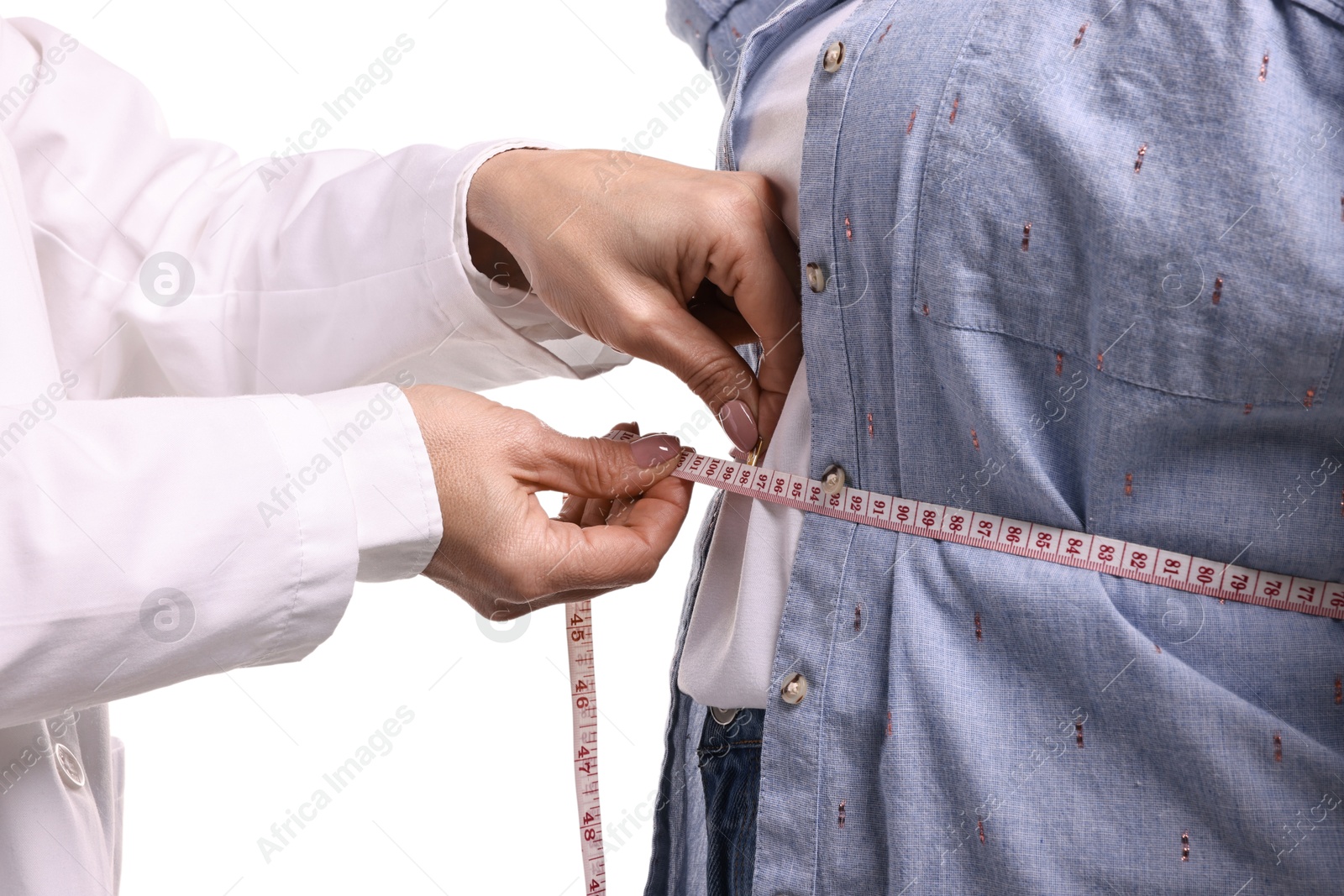 Photo of Weight loss. Nutritionist measuring patient's waist with tape on white background, closeup