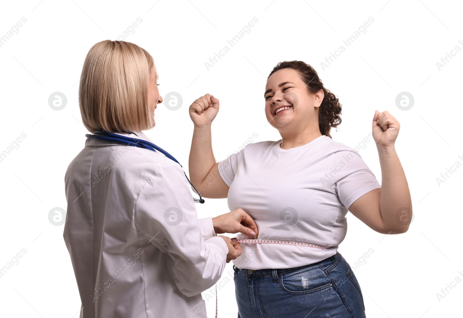 Photo of Happy woman lost weight. Nutritionist measuring patient's waist with tape on white background