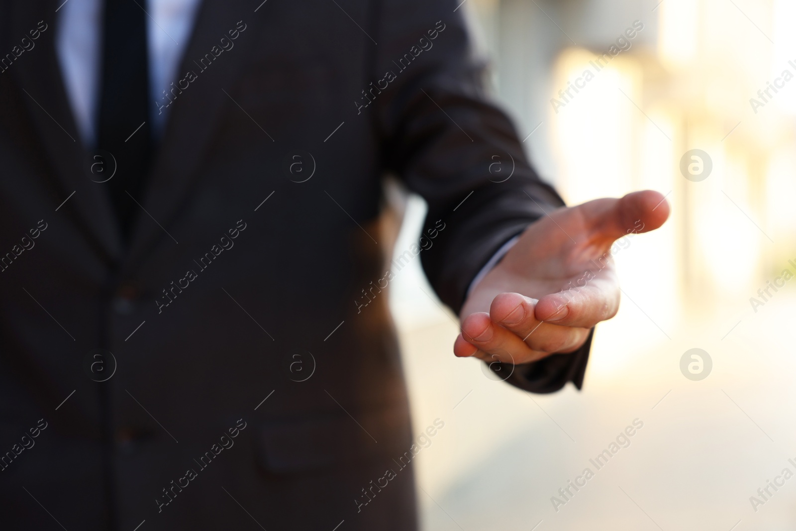 Photo of Man offering helping hand on city street, closeup