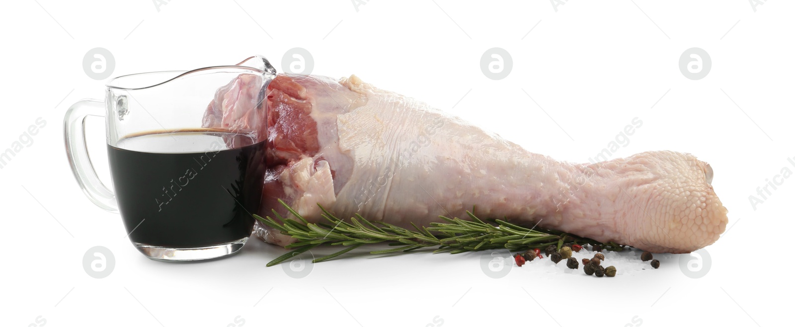 Photo of Raw turkey drumstick and spices isolated on white