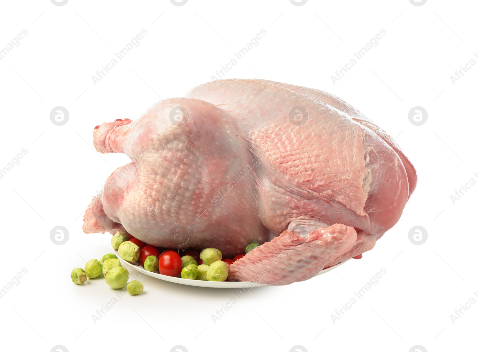 Photo of Whole raw turkey with vegetables isolated on white