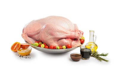 Photo of Whole raw turkey with ingredients isolated on white