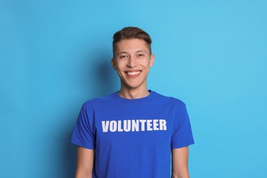 Photo of Portrait of smiling volunteer on light blue background