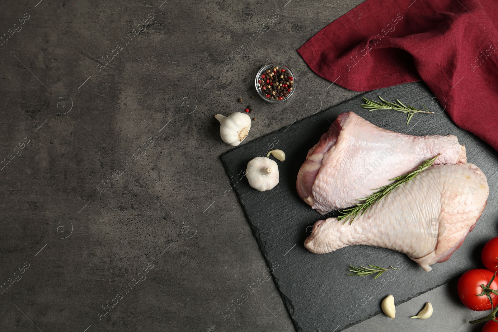 Photo of Raw turkey drumsticks and ingredients on grey table, flat lay. Space for text