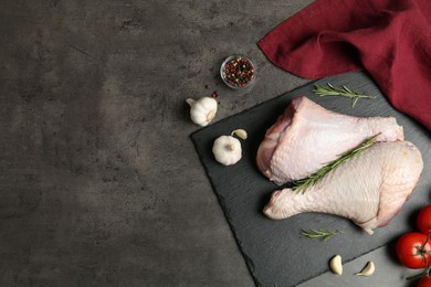 Photo of Raw turkey drumsticks and ingredients on grey table, flat lay. Space for text