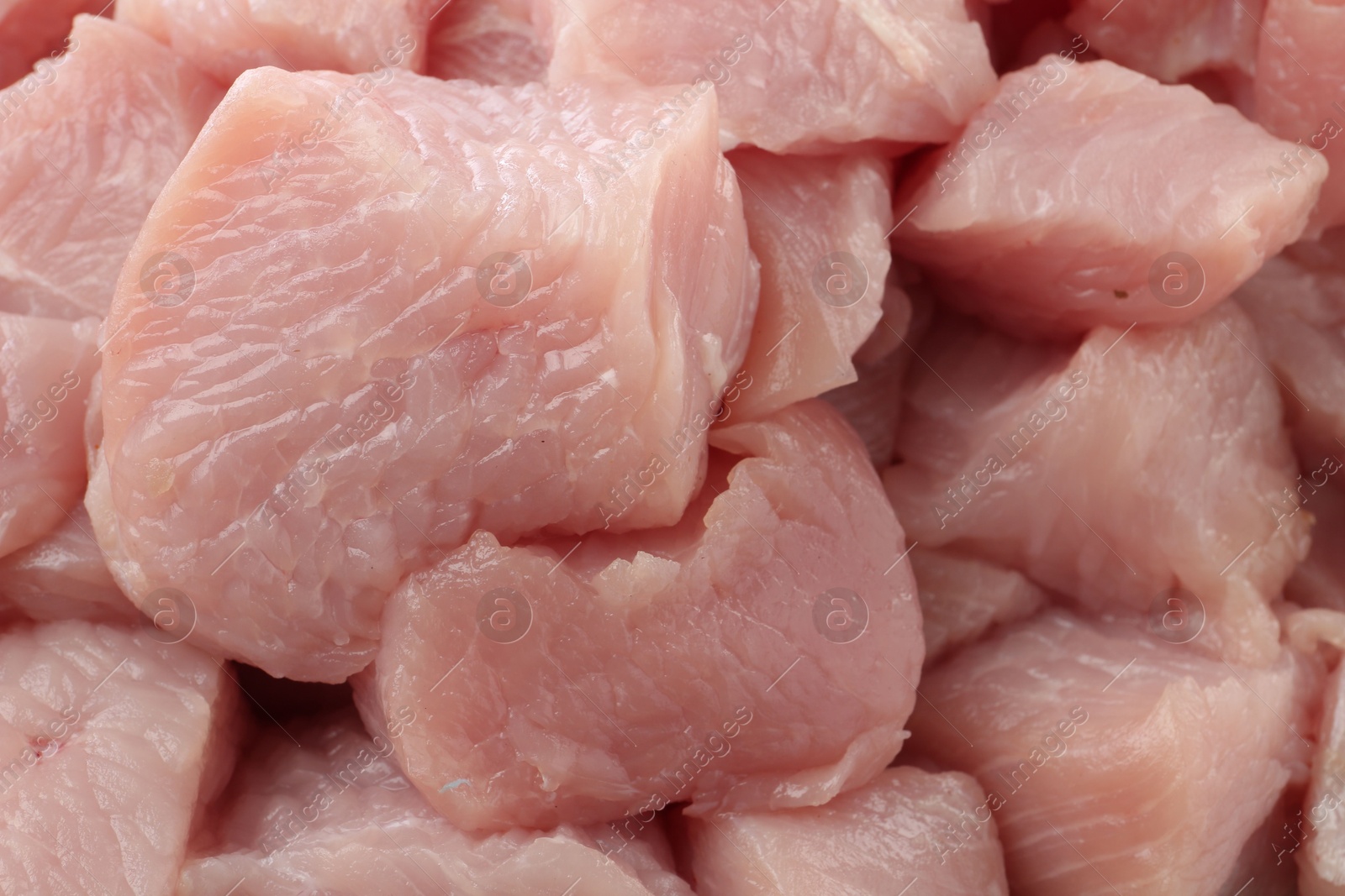 Photo of Pieces of raw turkey meat as background, closeup