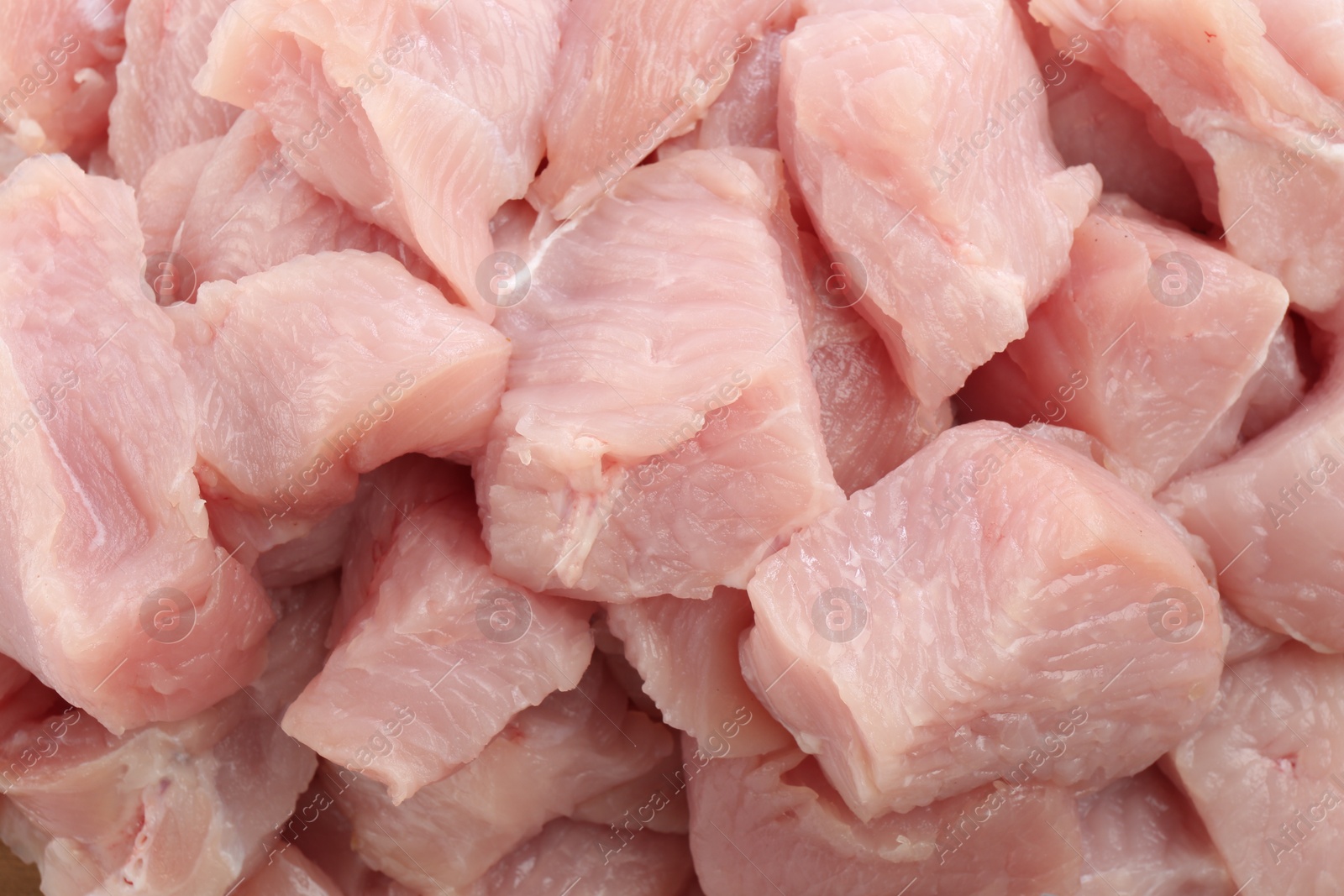 Photo of Pieces of raw turkey meat as background, closeup