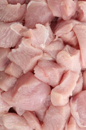 Photo of Pieces of raw turkey meat as background, closeup