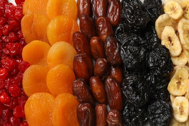 Photo of Different dried fruits as background, top view