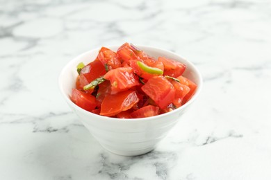 Photo of Delicious salsa on white marble table, closeup