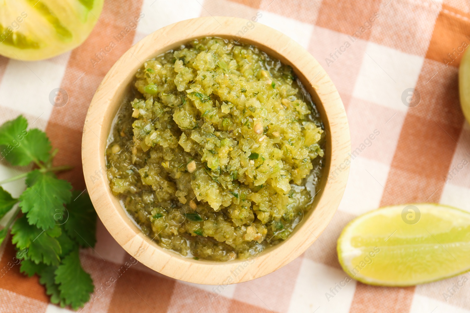 Photo of Spicy salsa and ingredients on table, top view