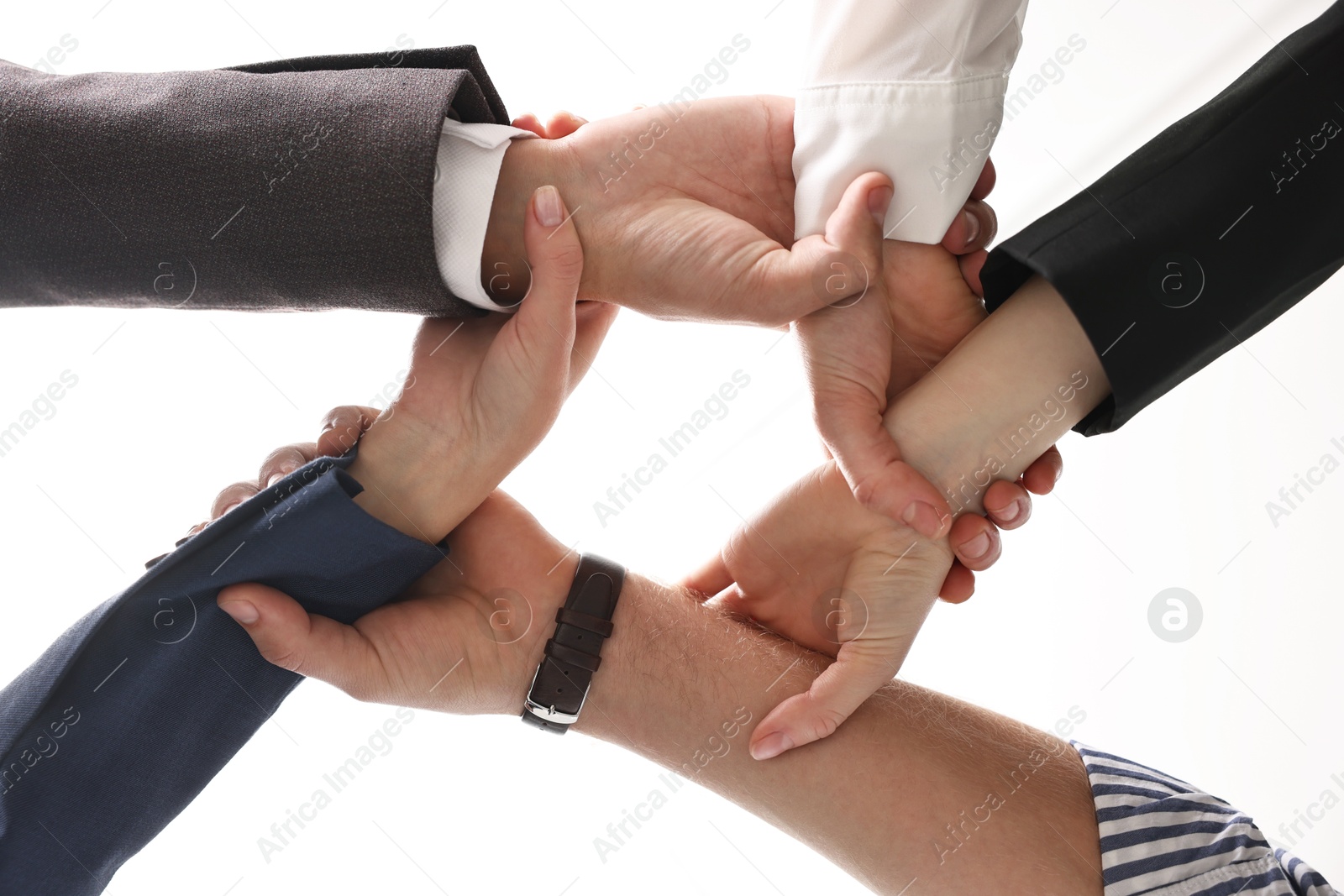 Photo of Teamwork. Group of people joining hands together indoors, bottom view