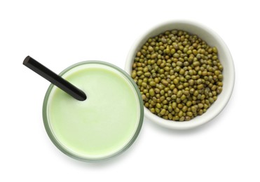 Photo of Fresh mung bean juice in glass and seeds isolated on white, top view