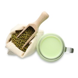 Photo of Fresh mung bean juice in mason jar, scoop and seeds isolated on white, top view