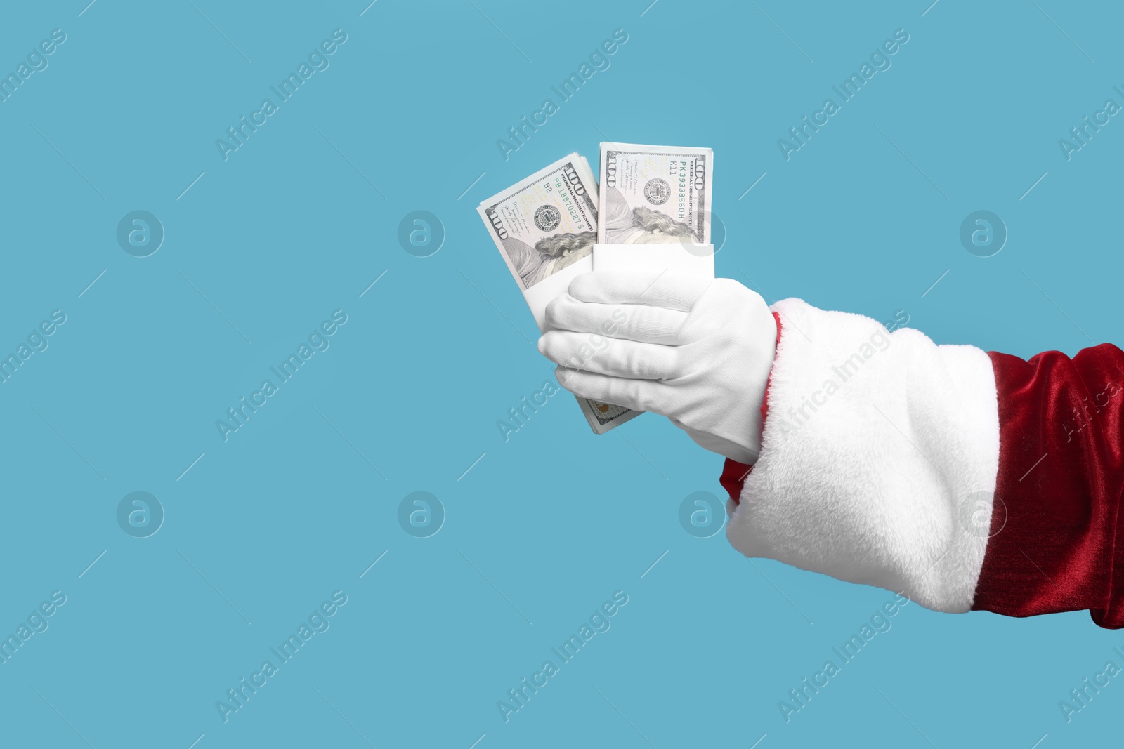 Photo of Santa Claus with dollar banknotes on light blue background, closeup. Space for text