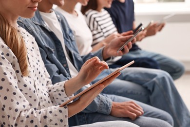 Group of people using different gadgets indoors, closeup. Modern technology