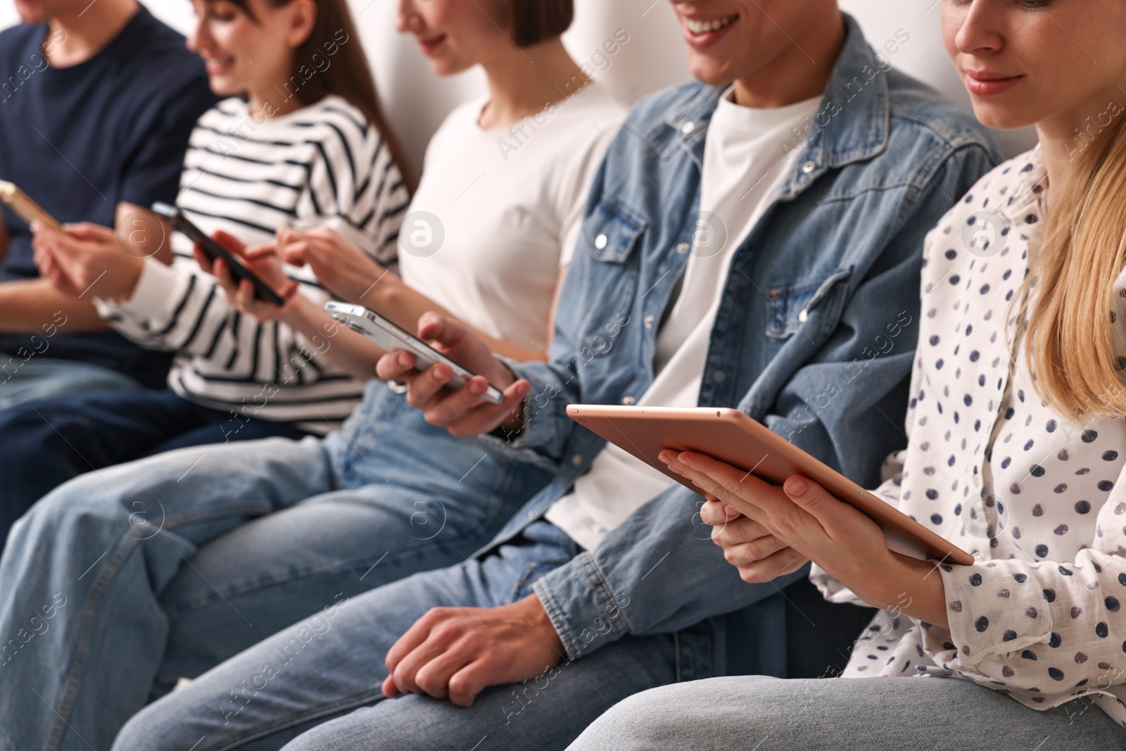 Photo of Group of people using different gadgets indoors, closeup. Modern technology