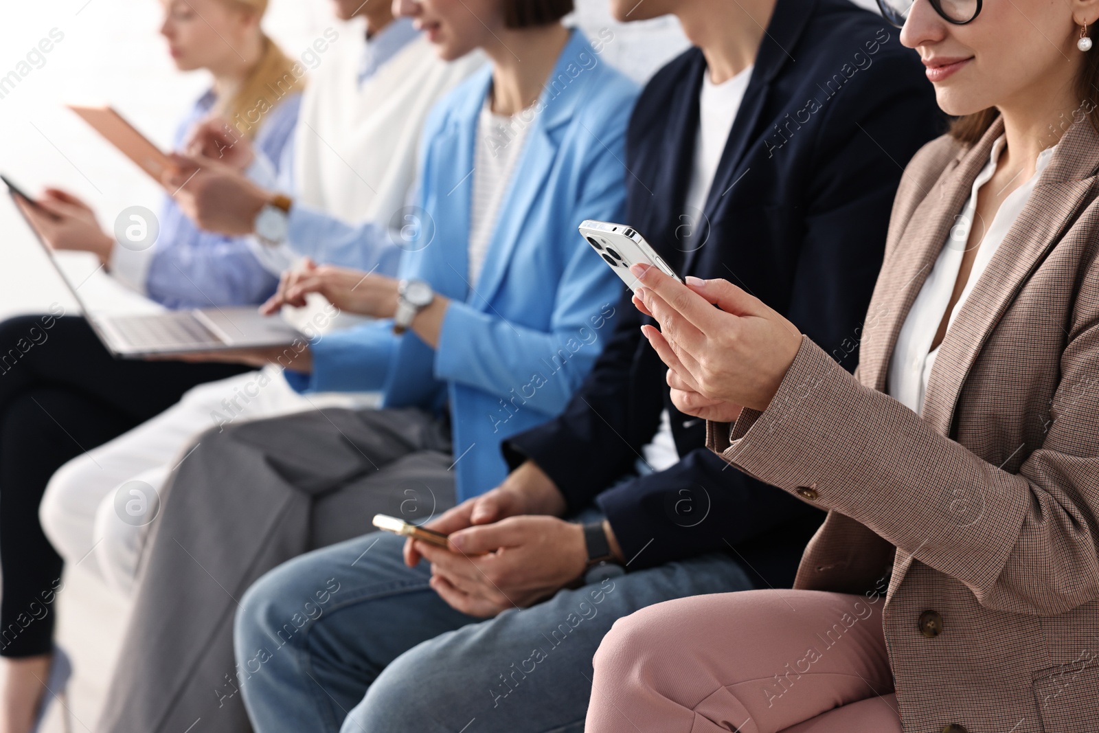 Photo of Group of people using different gadgets indoors, closeup. Modern technology