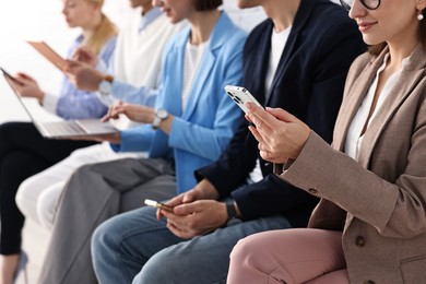 Photo of Group of people using different gadgets indoors, closeup. Modern technology