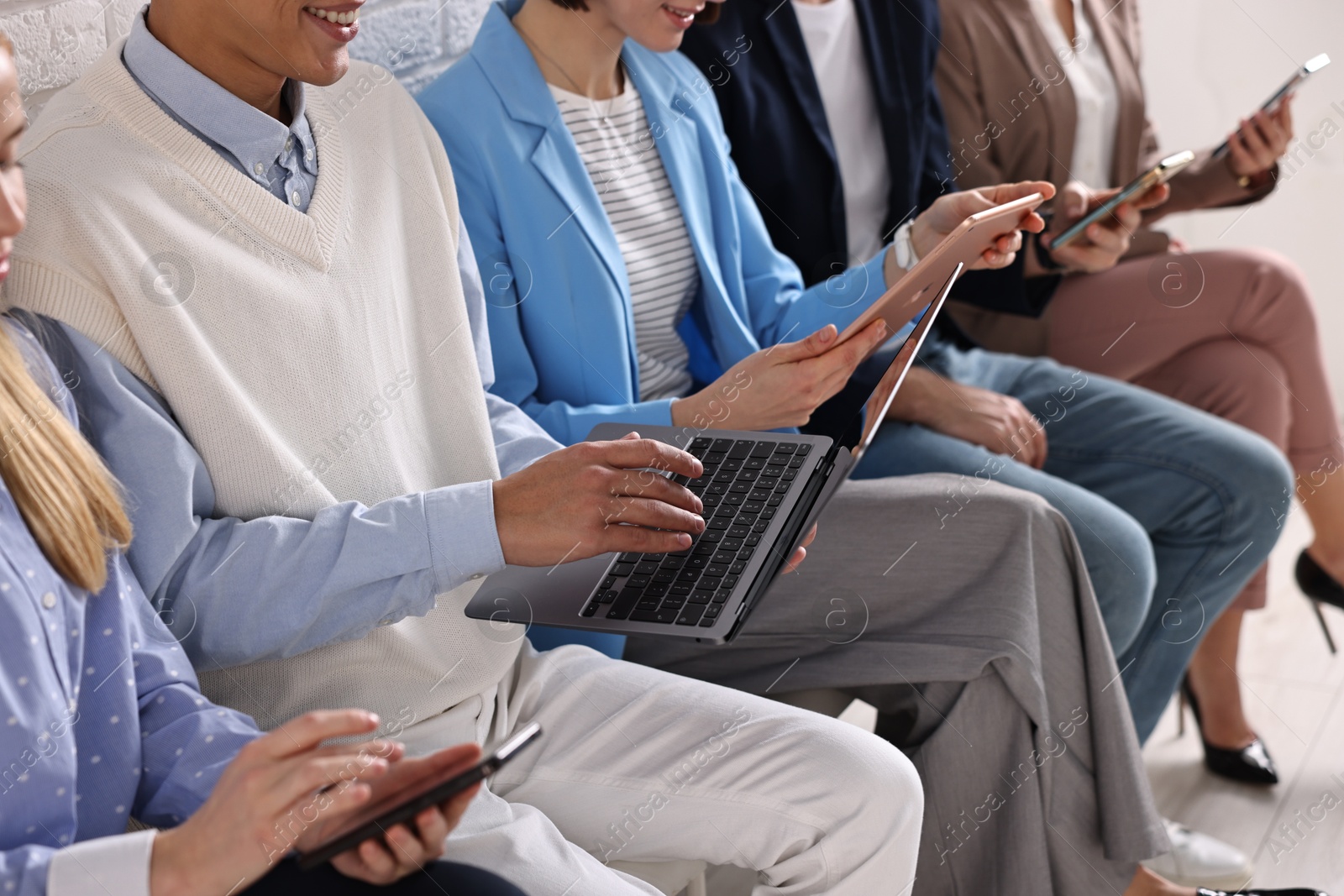 Photo of Group of people using different gadgets indoors, closeup. Modern technology