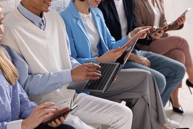 Group of people using different gadgets indoors, closeup. Modern technology