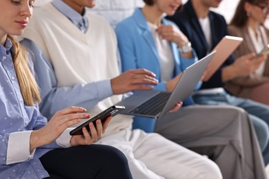 Group of people using different gadgets indoors, closeup. Modern technology