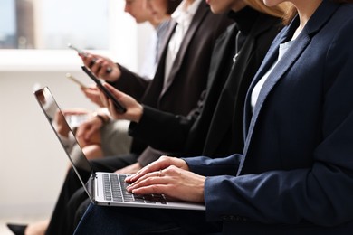 Group of people using different gadgets indoors, closeup. Modern technology