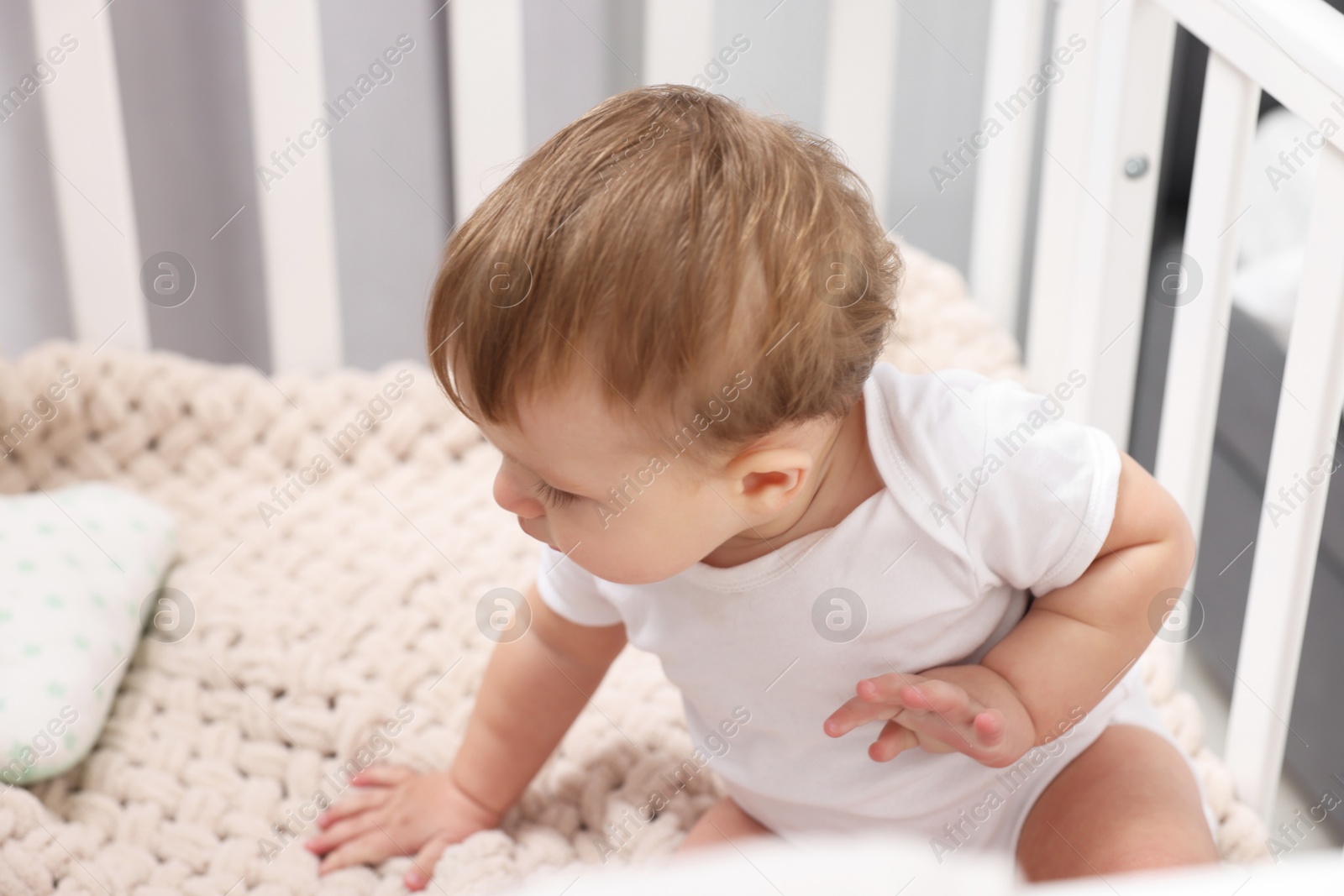 Photo of Cute little baby in crib at home