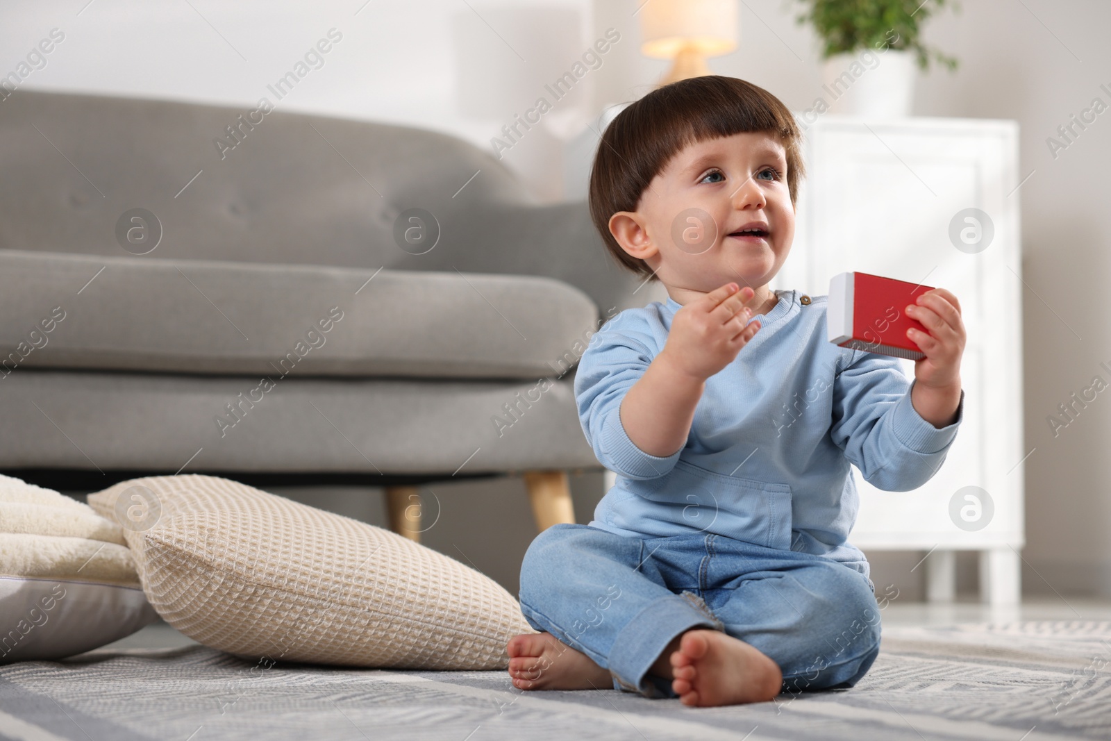 Photo of Little boy playing with matchbox at home. Child in danger