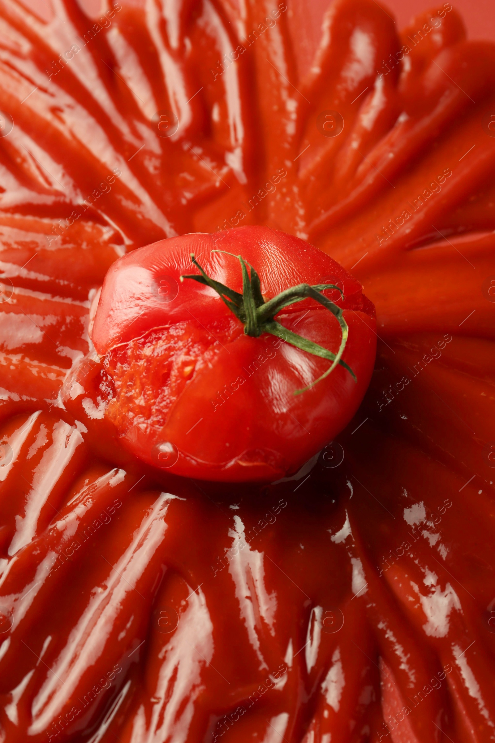 Photo of Tasty ketchup and tomato on red background, closeup