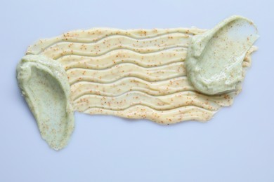 Photo of Samples of body scrub on light background, top view