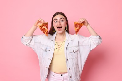 Emotional woman with delicious pizza on pink background