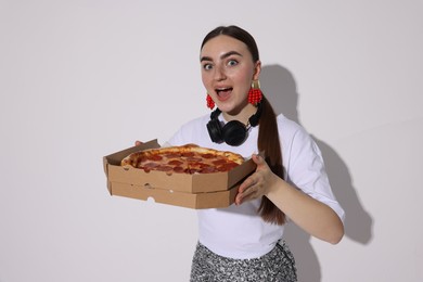 Photo of Surprised woman with delicious pizza on white background