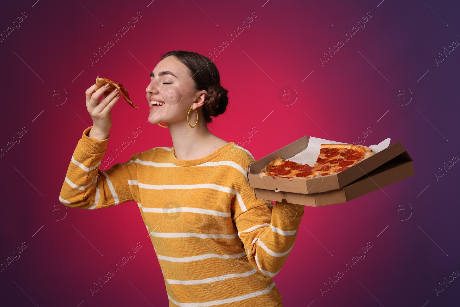 Photo of Beautiful woman with delicious pizza on bright background