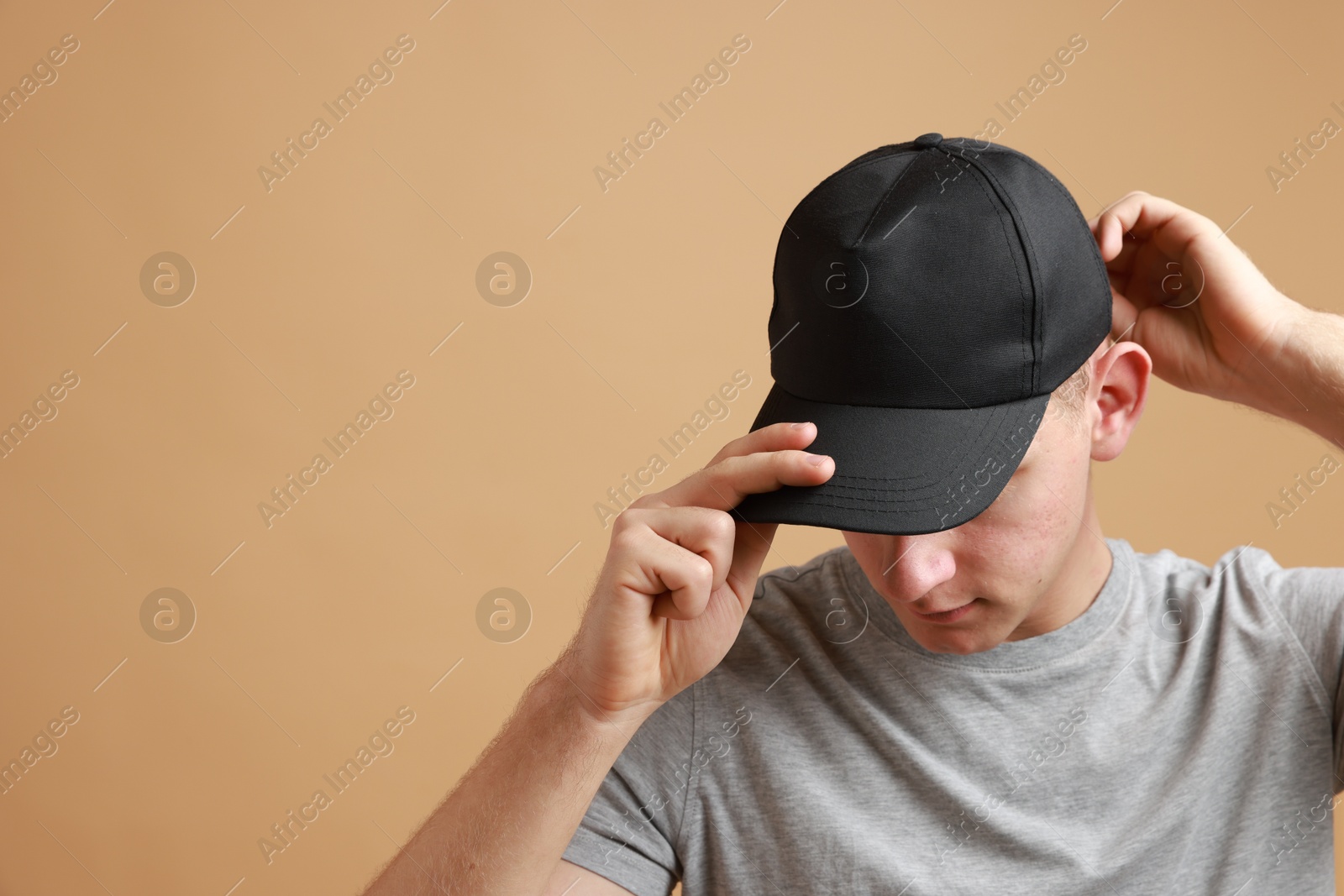 Photo of Man in stylish baseball cap on beige background. Mockup for design