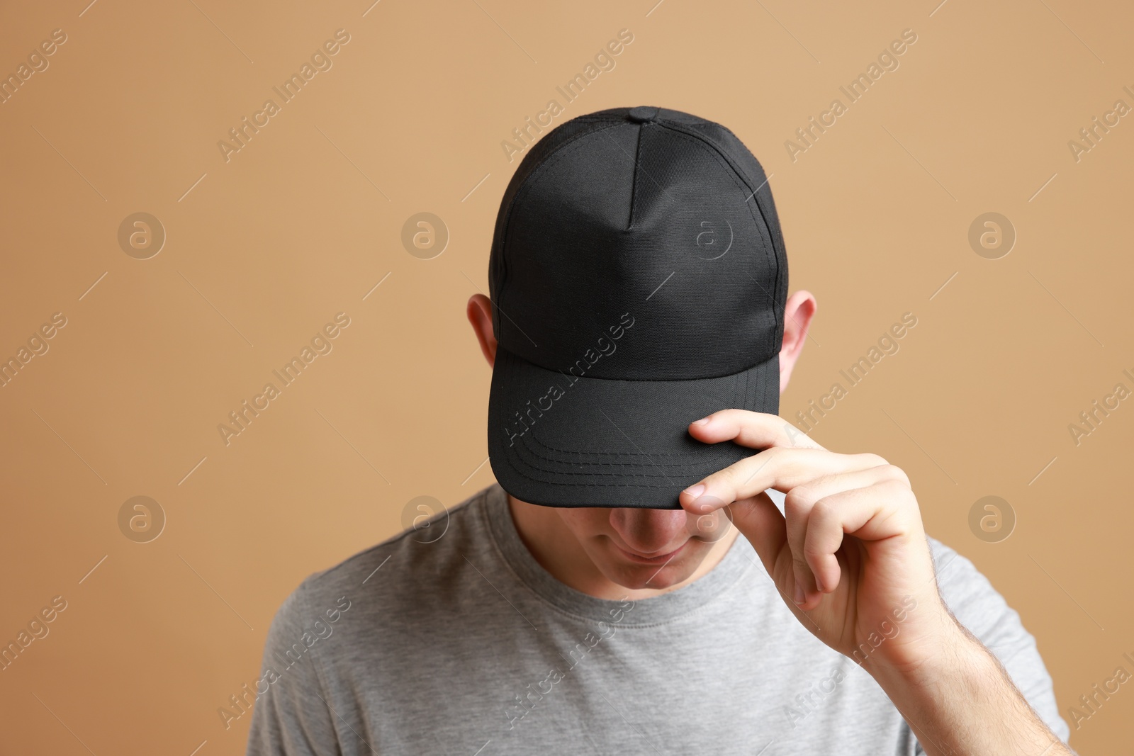 Photo of Man in stylish baseball cap on beige background. Mockup for design