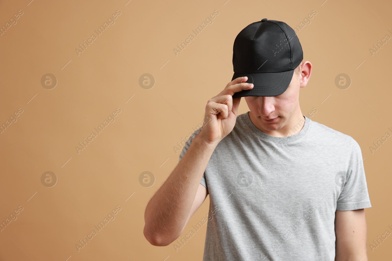 Photo of Man in stylish baseball cap on beige background. Mockup for design