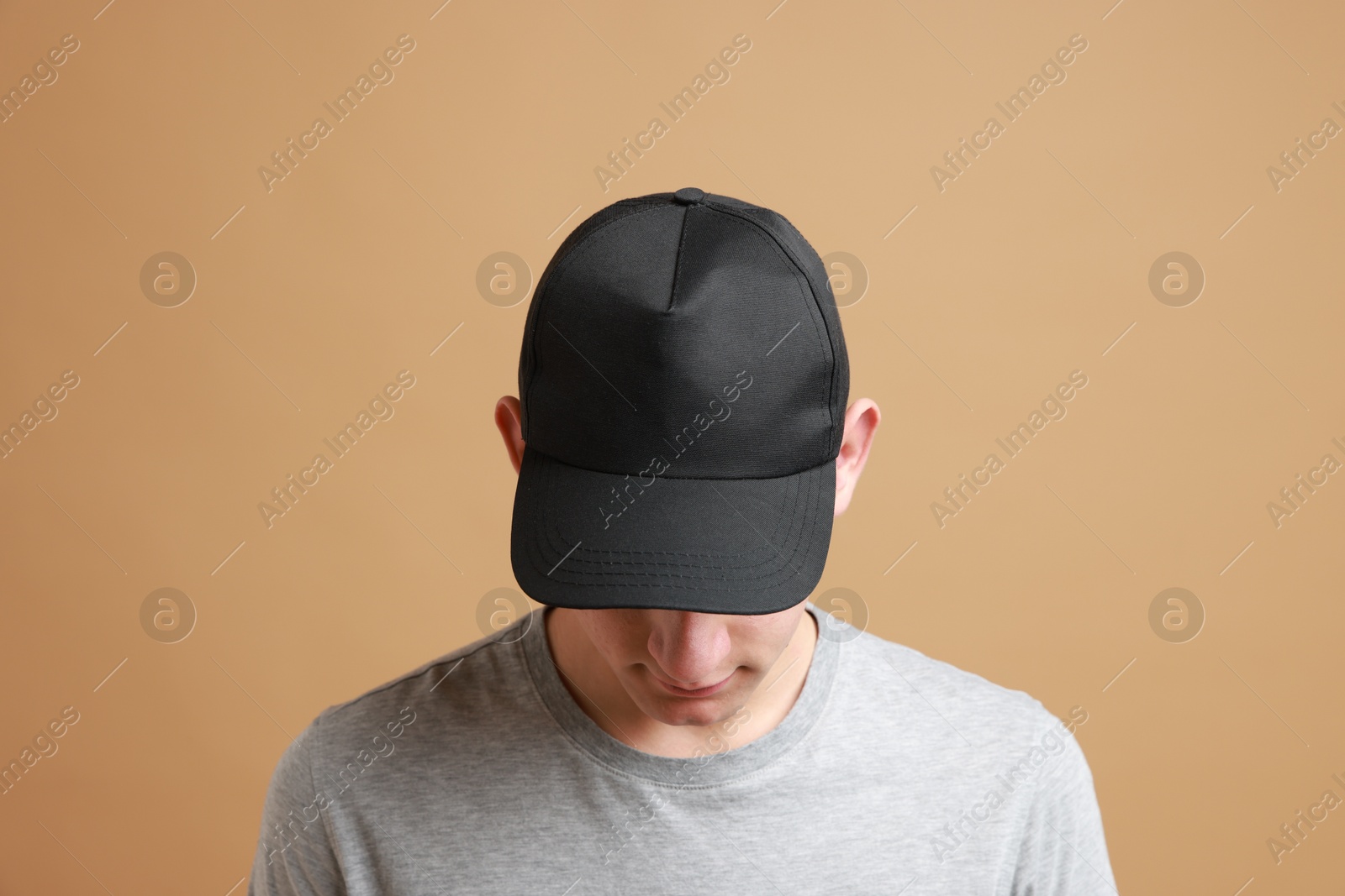 Photo of Man in stylish baseball cap on beige background. Mockup for design